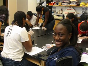 Scholar from the Class of 2010 smiling at the camera during her senior science course.