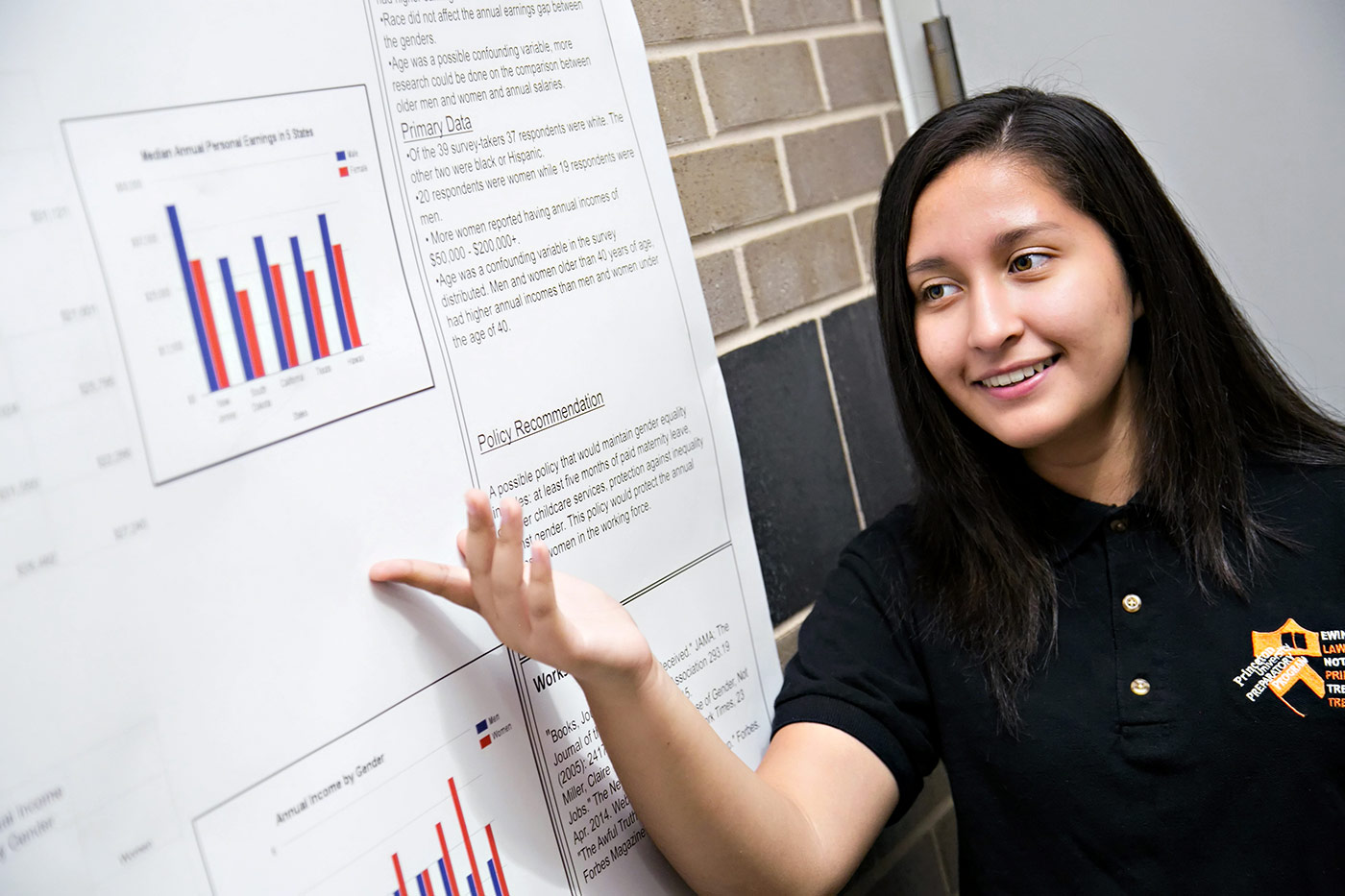 Scholar from the Class of 2017 presenting her science research project at the annual Research Symposium